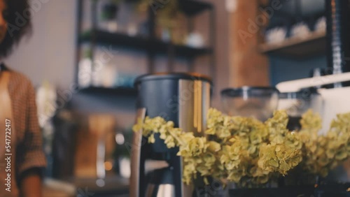 Smiling coffee shop employee serving coffee take-out to client, urban lifestyle