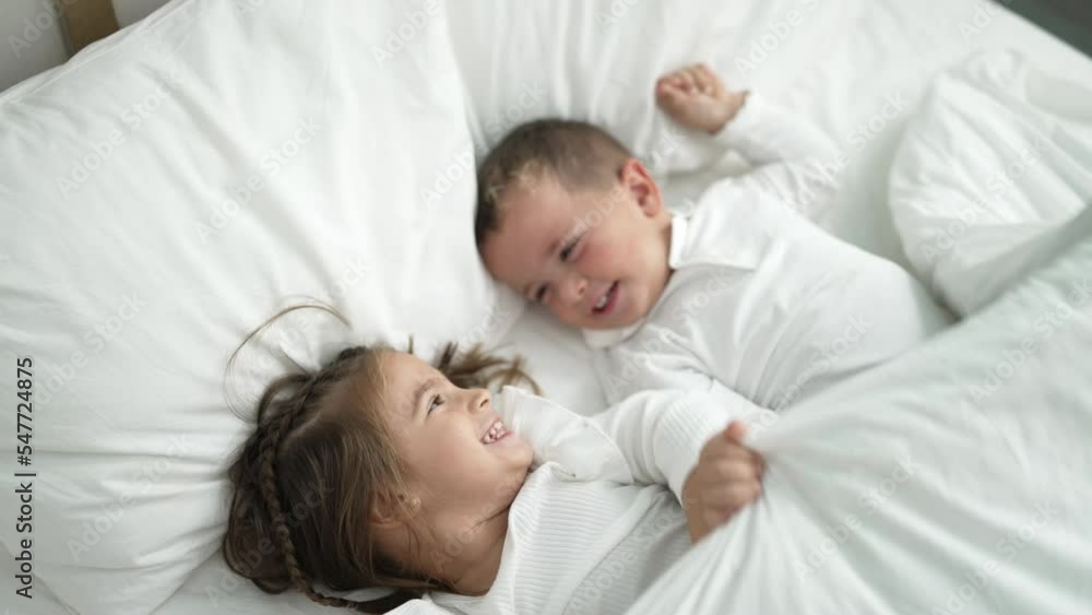Adorable girl and boy smiling confident covering with blanket at bedroom Adorable girl and boy smiling confident covering with blanket at bedroom