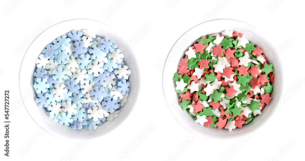 Snowflake and star shaped confetti sprinkles, in white bowls. Confetti candy, confectionery product, made of sugar and rice, consisting of flat multicolored candy sprinkles, used as edible decoration. Snowflake and star shaped confetti sprinkles, in white bowls. Confetti candy, confectionery product, made of sugar and rice, consisting of flat multicolored candy sprinkles, used as edible decoration.