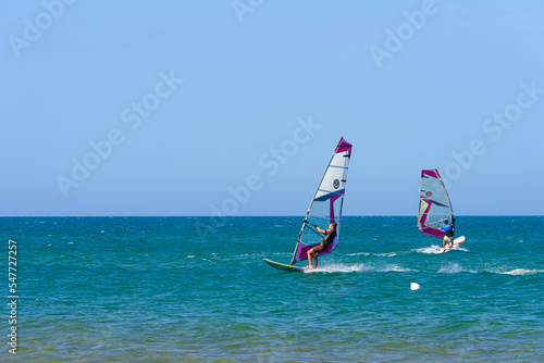 Wallpaper Mural Vieste, Italy. In the sea of Vieste, near the Scialmarino beach, two people practice windsurfing. September 7, 2022 Torontodigital.ca