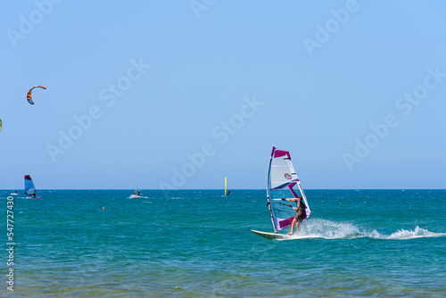 Vieste, Italy. In the sea of Vieste, near the Scialmarino beach, some people practice windsurfing and others practice kitesurfing. September 7, 2022 photo