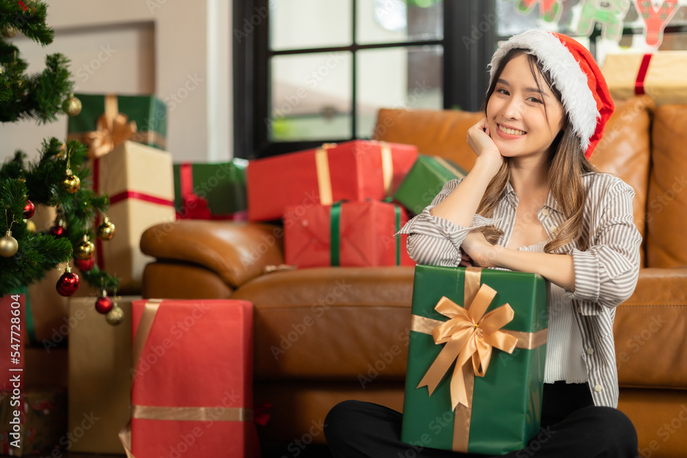 Excited asian woman getting surprise gift from her girlfriend at home. Gives a gift.Asian woman decor bauble ball christmas tree in xmas holiday winter seasonal celebration Excited asian woman getting surprise gift from her girlfriend at home. Gives a gift.Asian woman decor bauble ball christmas tree in xmas holiday winter seasonal celebration