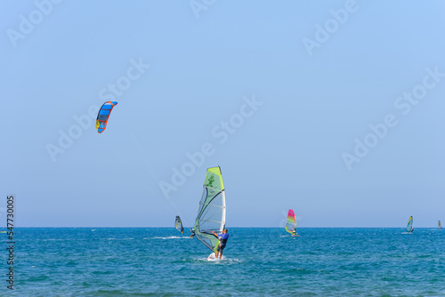 Vieste, Italy. In the sea of Vieste, near the Scialmarino beach, some people practice windsurfing and others practice kitesurfing. September 7, 2022