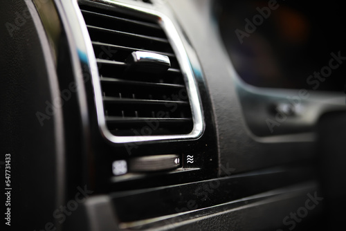 The process of choosing climate control in the car. Various controls in auto switches. Modern car interior © alexkich