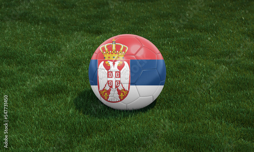 Soccer ball with Serbia flag colors at a stadium on green grasses background.