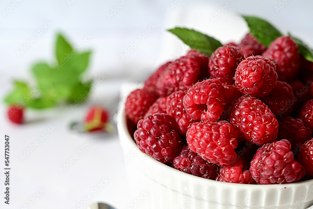 Juicy ripe raspberries in a plate on a white backgroundripe raspberries in a white plate on a white background, vitamins for the body Juicy ripe raspberries in a plate on a white backgroundripe raspberries in a white plate on a white background, vitamins for the body