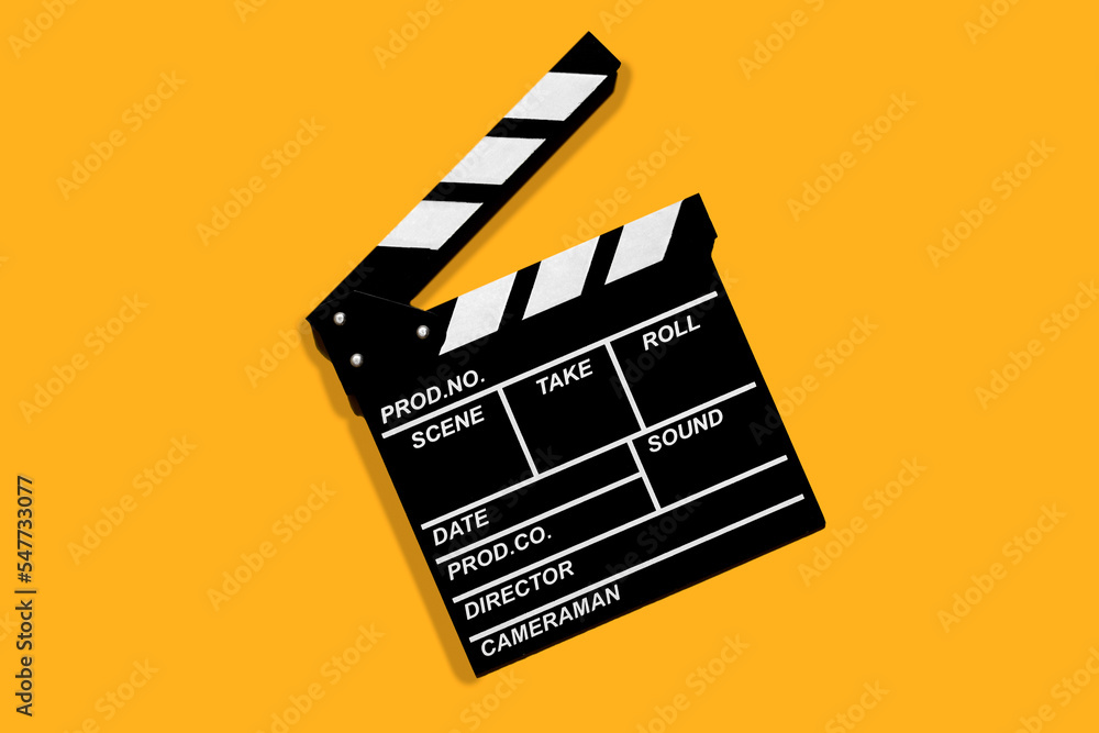 Naklejka premium Clapperboard for shooting video footage takes on a orange background