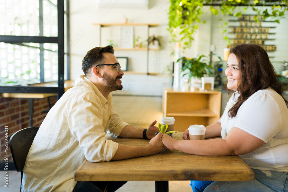 Happy boyfriend and girlfriend enjoying a coffee date Happy boyfriend and girlfriend enjoying a coffee date