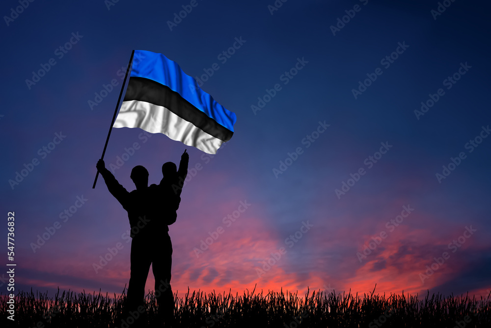 Father and son hold the flag of Estonia