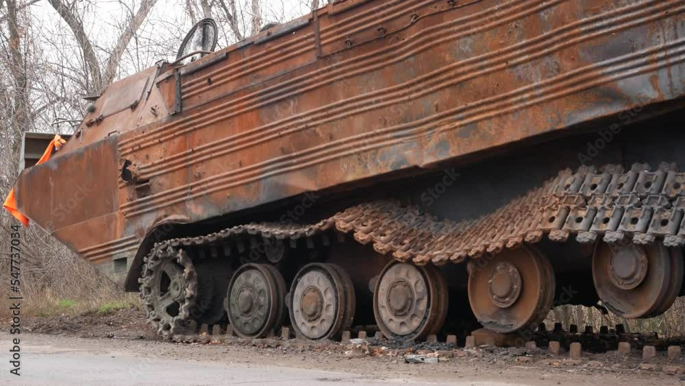 A rusty knocked out tank of the Russian army on the road. A rusty hull and damaged tracks are visible. Russian-Ukrainian war 2022. Ukrainian counteroffensive A rusty knocked out tank of the Russian army on the road. A rusty hull and damaged tracks are visible. Russian-Ukrainian war 2022. Ukrainian counteroffensive