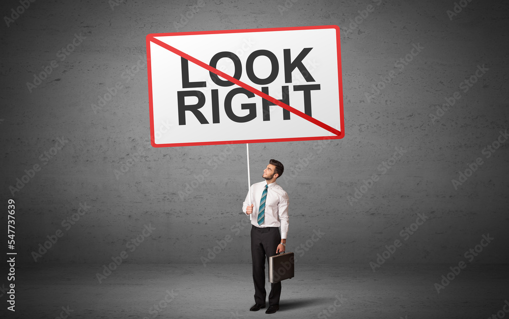 business person holding a traffic sign business person holding a traffic sign
