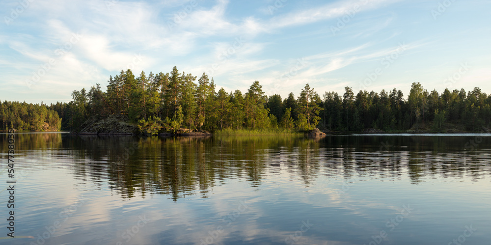 forest lake with rocky island and reflection