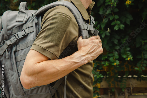 Cadet with a backpack on a background of greenery. Military education. military student. Concept of learning. photo