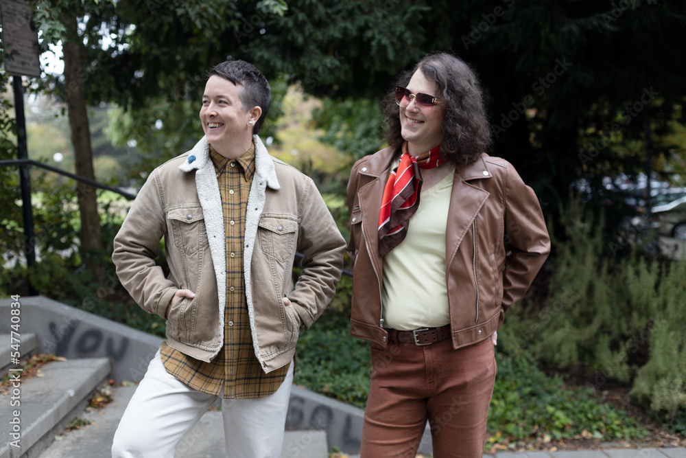 Fototapeta premium lifestyle image of transgender nonbinary friends talking in the park