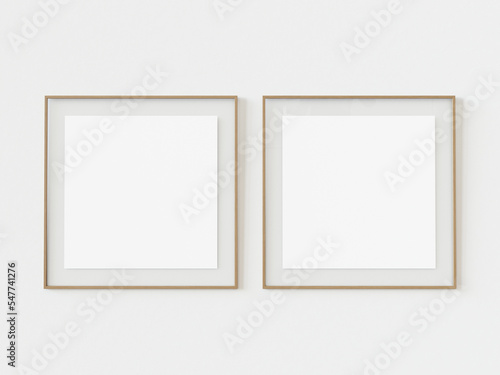 Set of two wooden square photo frames on white wall background. Empty brown picture photo frame mockup template isolated on white wall indoors. 3d illustration