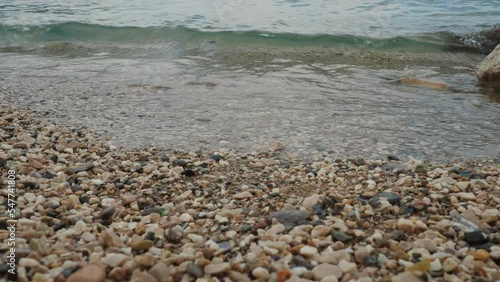 Adriatic Sea, Montenegro, Mediterranean Meljine Herceg Novi. Calm waves of salty water wash over the rocky shore. Clear water and multi-colored rounded pebbles. Travel business. Beach vacation photo