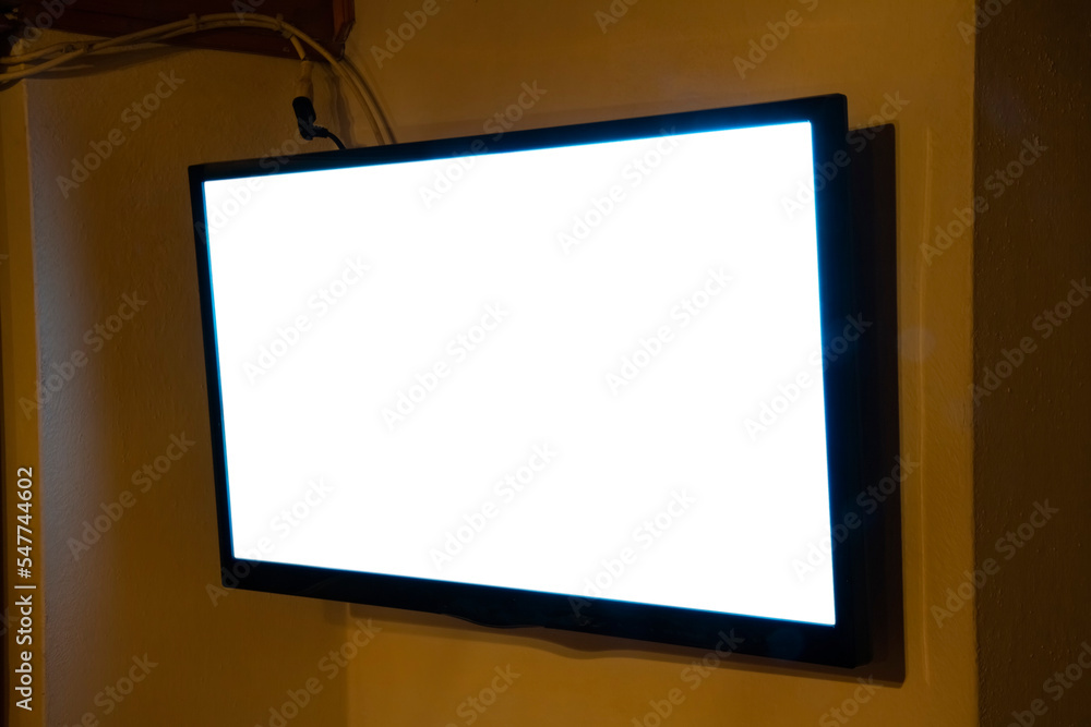 A flat TV set mounted on the wall of a room. Angled shot, blank cutout screen.
A flat TV set mounted on the wall of a room. Angled shot, blank cutout screen.
