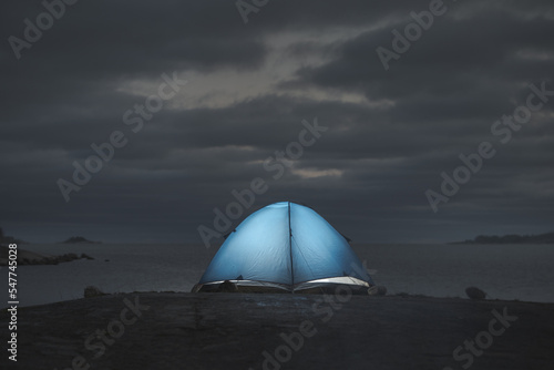 Glowing tent on the coast.