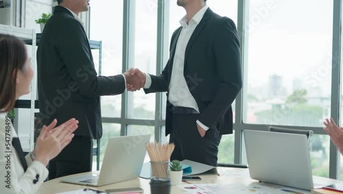 Close-up hand Asian male hands handshake. Business partners negotiate sign contract handshake. While Asian group meeting of Business male and Business female successful.
