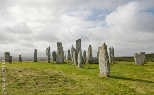 Standing stones of Callanish in sunlight and with cloudy sky
