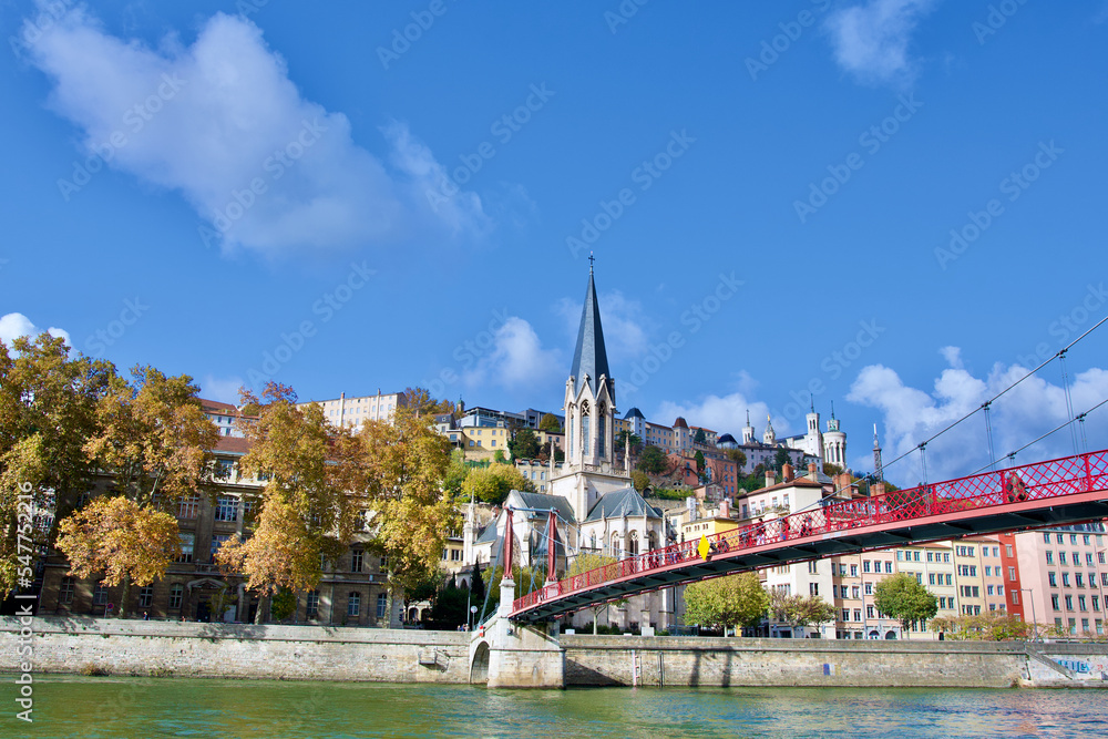 Autumn panorama of old lyon in France with in the foreground the river Saône, the Saint George church, the Saint George footbridge , and the basilica Notre Dame de fourvière on the heights Autumn panorama of old lyon in France with in the foreground the river Saône, the Saint George church, the Saint George footbridge , and the basilica Notre Dame de fourvière on the heights