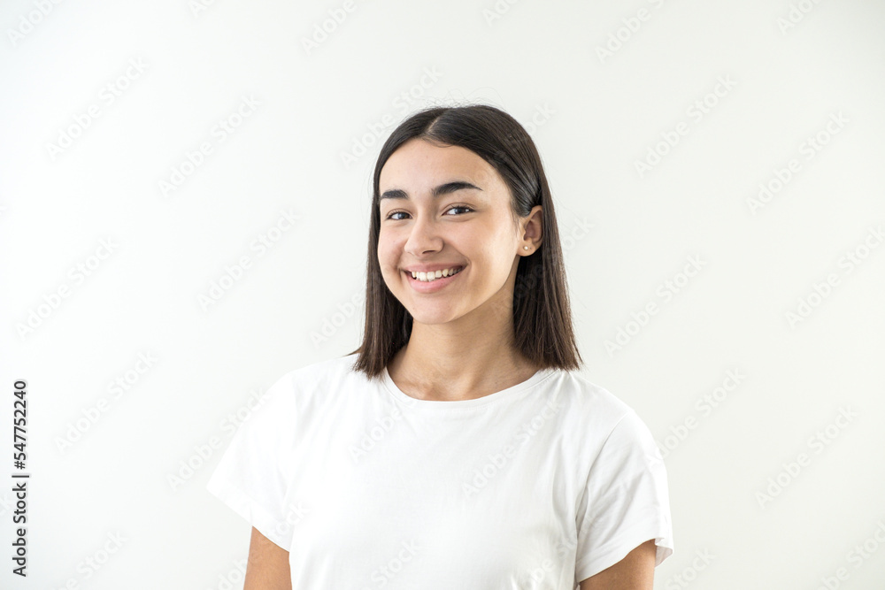 Happy and smiling young girl looking at camera in studio Happy and smiling young girl looking at camera in studio
