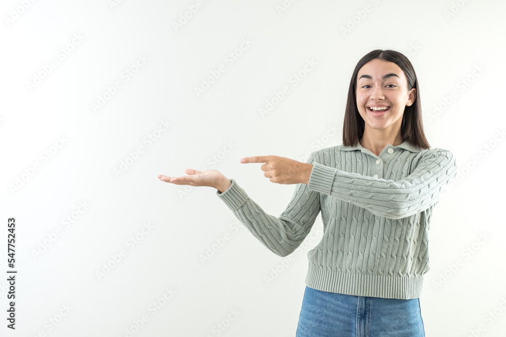 Happy girl offering and presenting a product or message over hand in empty space copy Happy girl offering and presenting a product or message over hand in empty space copy