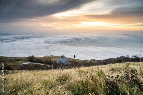 Beautiful view of surfing clouds on Mt. Nanos above St. Jerome church, Slovenia photo
