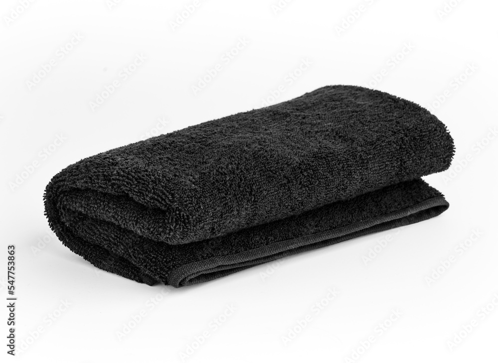 Black towel isolated on white background. Black color folded hand towel