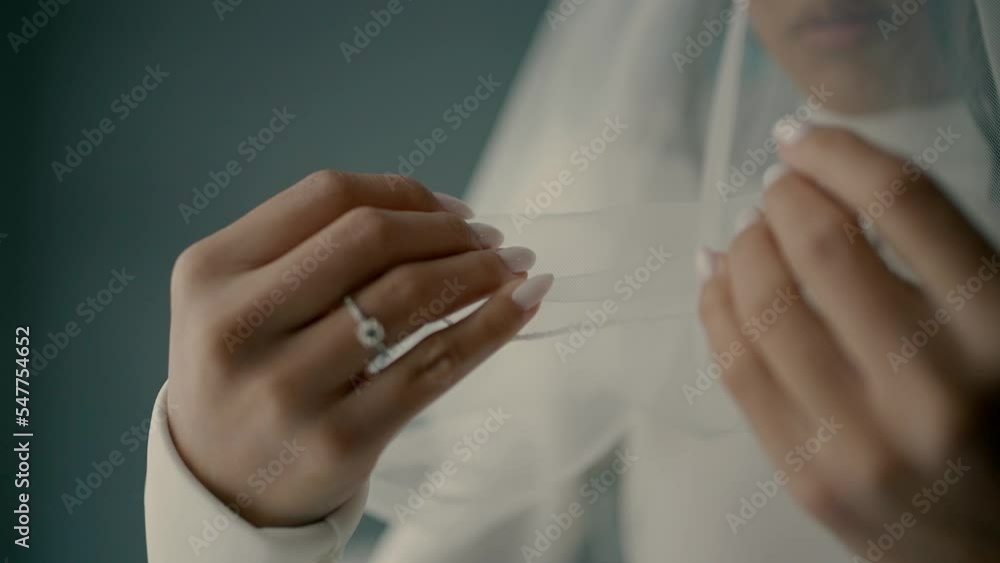 bride fingering veil, Close-up slow motion video shoot of the bride on the wedding day in the room bride fingering veil, Close-up slow motion video shoot of the bride on the wedding day in the room