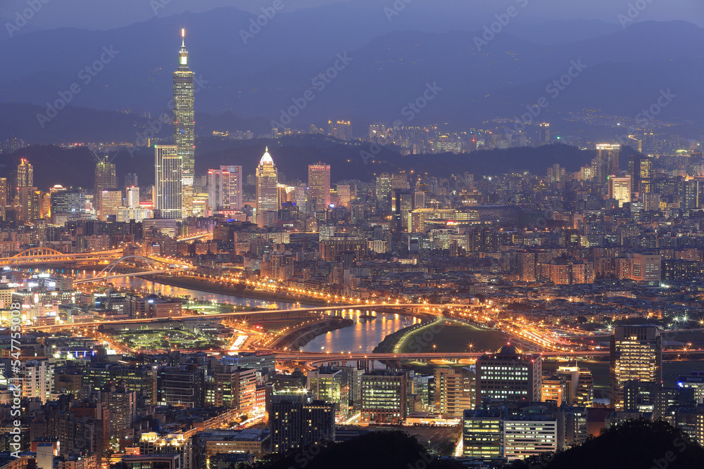 Night scenery of Downtown Taipei, with view of bridges over Keelung River & Taipei 101 Tower among skyscrapers in Xinyi Financial District ~ Romantic nightscape of a busy city in a gloomy mood