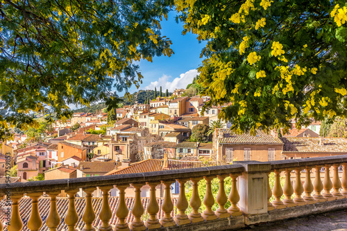 Scenic view of the small village of Bormes le Mimosas in south of France with yellow mimosas blooming under warm winter sunlight