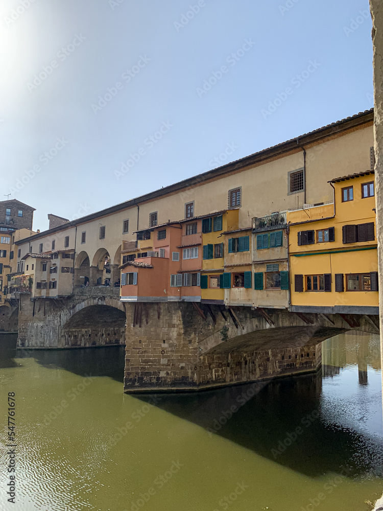 Firenze, Tuscany, Italy - 18.10.2022. Famous landmark Ponte Vecchio in Florence. Ponte Vecchio bridge over Arno river in Florence, Italy. Picturesque medieval arched river bridge with Roman origins