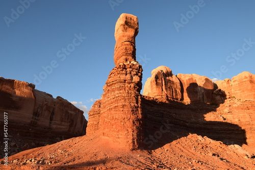 Red sandstone rock formations in the desert at golden hour (sunset), throwing long shadows