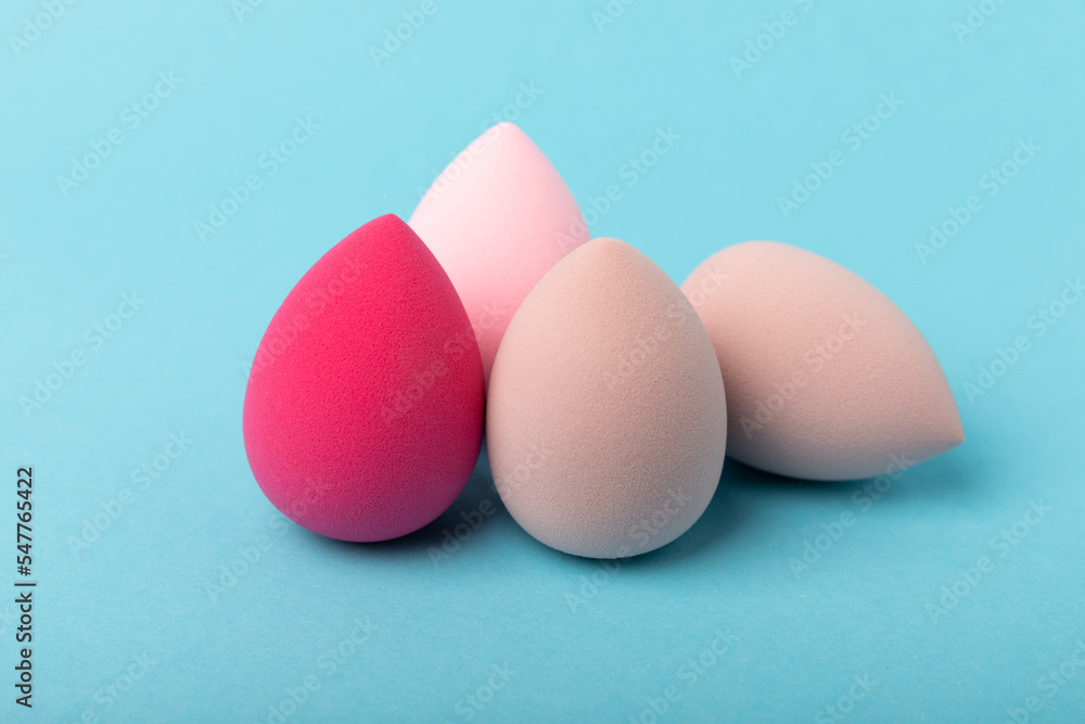 Beauty blender. Cosmetic sponge on a blue background. MOCAP. Sponge for applying foundation and concealer. Beauty concept. Space for text. Space for copy space. Beauty blender. Cosmetic sponge on a blue background. MOCAP. Sponge for applying foundation and concealer. Beauty concept. Space for text. Space for copy space.