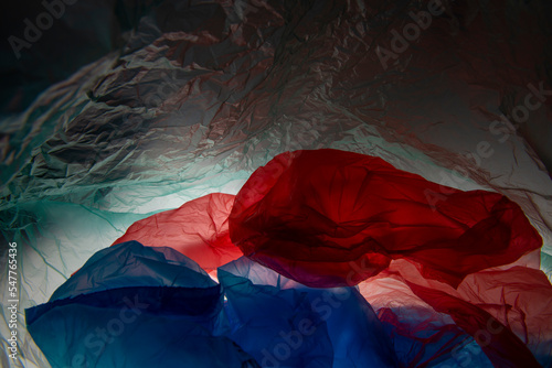 transparent cellophane colored bags close-up background texture of plastic