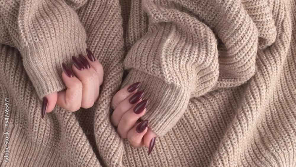 Beautiful hands of a young woman with dark red manicure on nails.
Beautiful hands of a young woman with dark red manicure on nails.