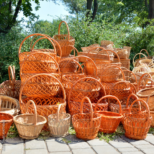 Many wicker baskets are stacked in one place.