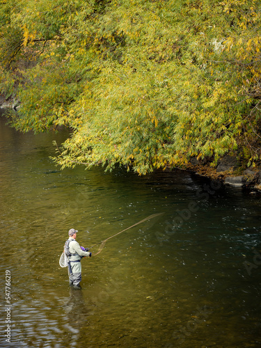 Man fishing in the Boise river in autumn