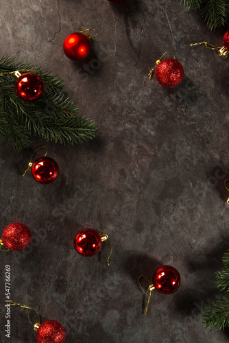 balls and Christmas tree branches on a dark background.