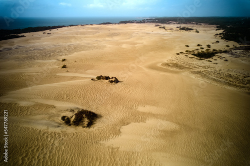 Aerial Drone Image over Nags Head on the Outer Banjs of North Carolina's Jockey Ridge Park and the massive sand dunes that reside about quarter mile inland with Currituck Sound in the background photo