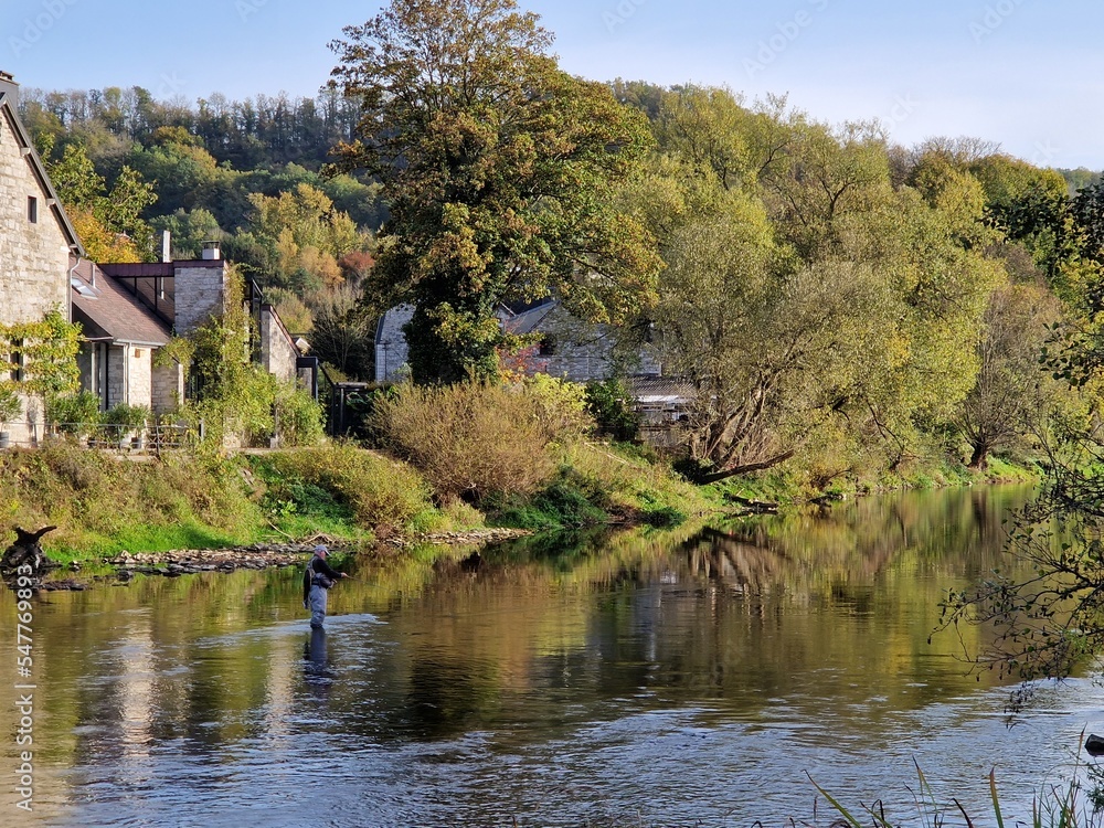 Elderly man fishing in river Ourthe in Comblain-la-Tour, Belgian Ardennes Elderly man fishing in river Ourthe in Comblain-la-Tour, Belgian Ardennes