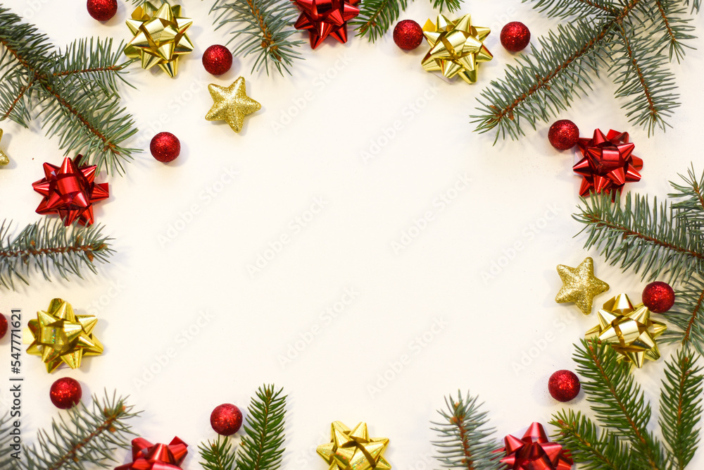 Christmas tree branches, red balls and stars, New Year's decor on a white background. Christmas frame for your text Christmas tree branches, red balls and stars, New Year's decor on a white background. Christmas frame for your text