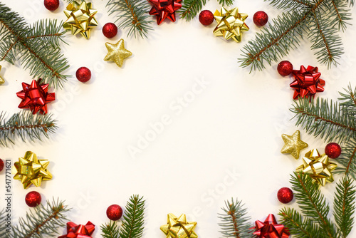 Christmas tree branches  red balls and stars  New Year s decor on a white background. Christmas frame for your text