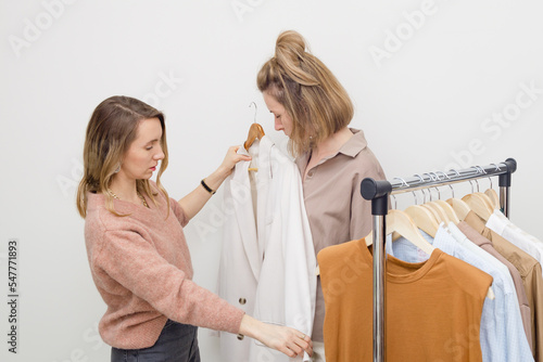 Female stylist and client - wardrobe organization concept.