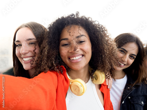 Three multi-ethnic young female friends having fun. Selfie Perspective