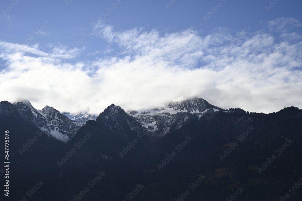 clouds over the mountains, alps in austria, blue sky with clouds