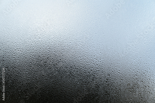 Dew drops and condensation on glass, cold season and high humidity on windows in houses. photo