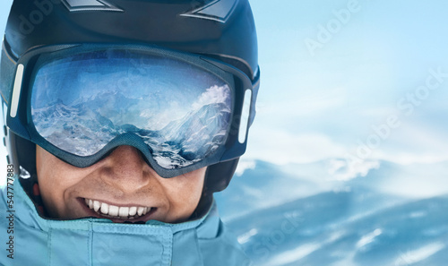 Fotografie, Obraz Close up of the ski goggles of a man with the reflection of snowed mountains