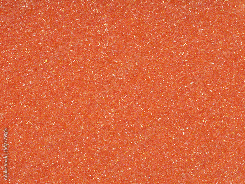 Bright soft orange holographic glitter. Abstract shiny background. Design paper texture for decoration and design of Christmas, New Year, 3d, or other holiday pictures. Beautiful packaging material.